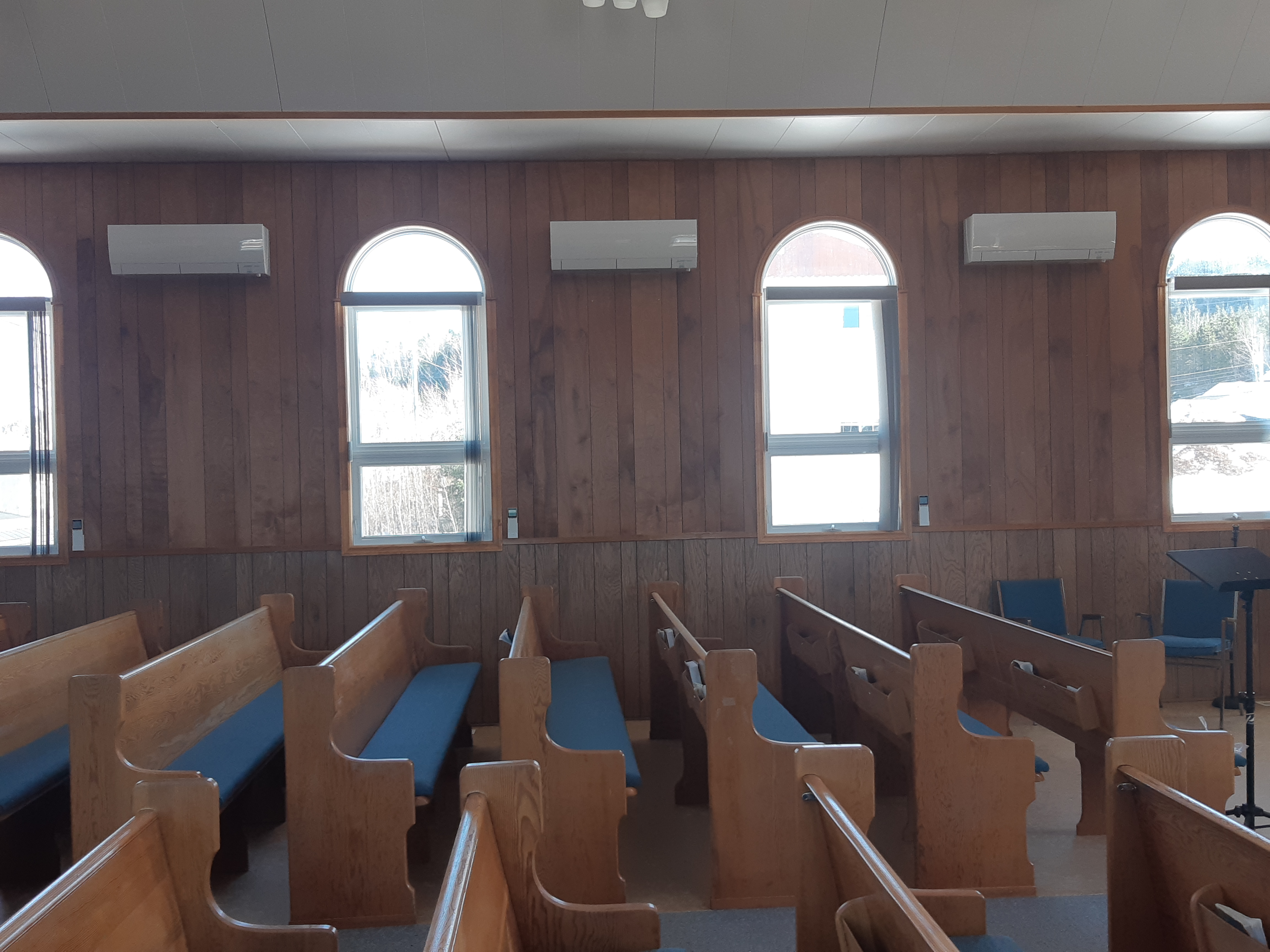 the hall of a church with heat pumps on the walls