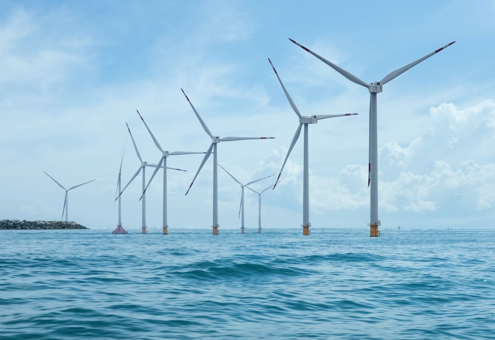 Image of an offshore wind farm against a clear blue sky