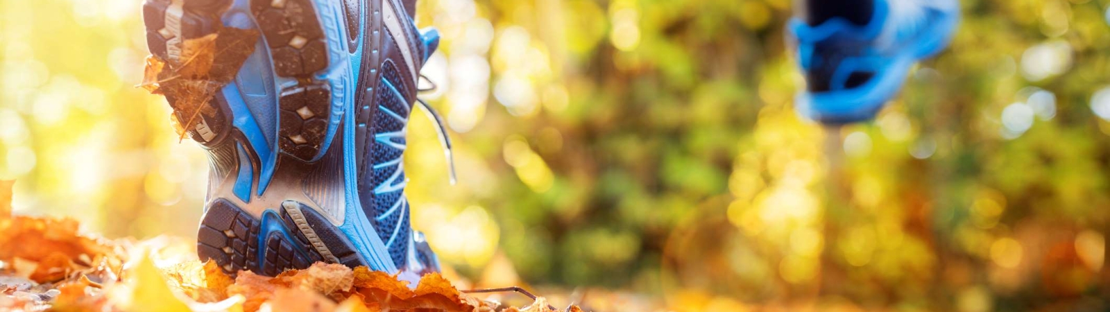 a person running over fall leaves