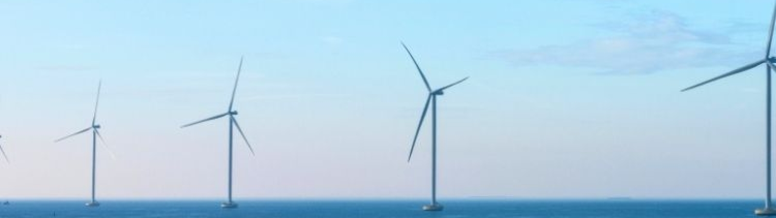 Image of an offshore wind farm against a clear blue sky