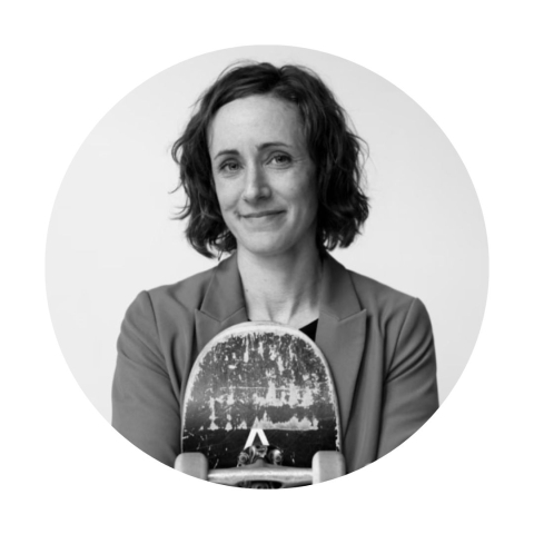 Circular headshot of Natasha holding a skateboard and smiling