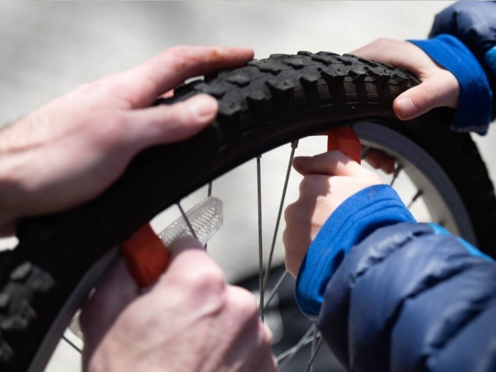 hands holding bike tire.