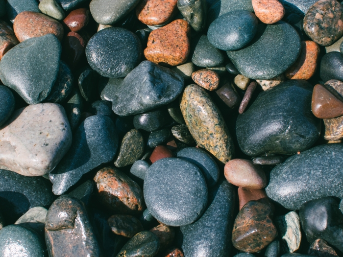 a close up photo of rocks on a beach