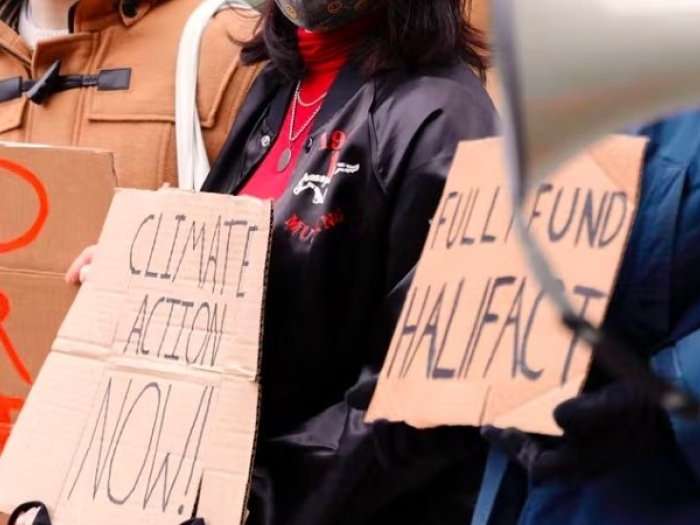 Teens holding protest signs against climate change